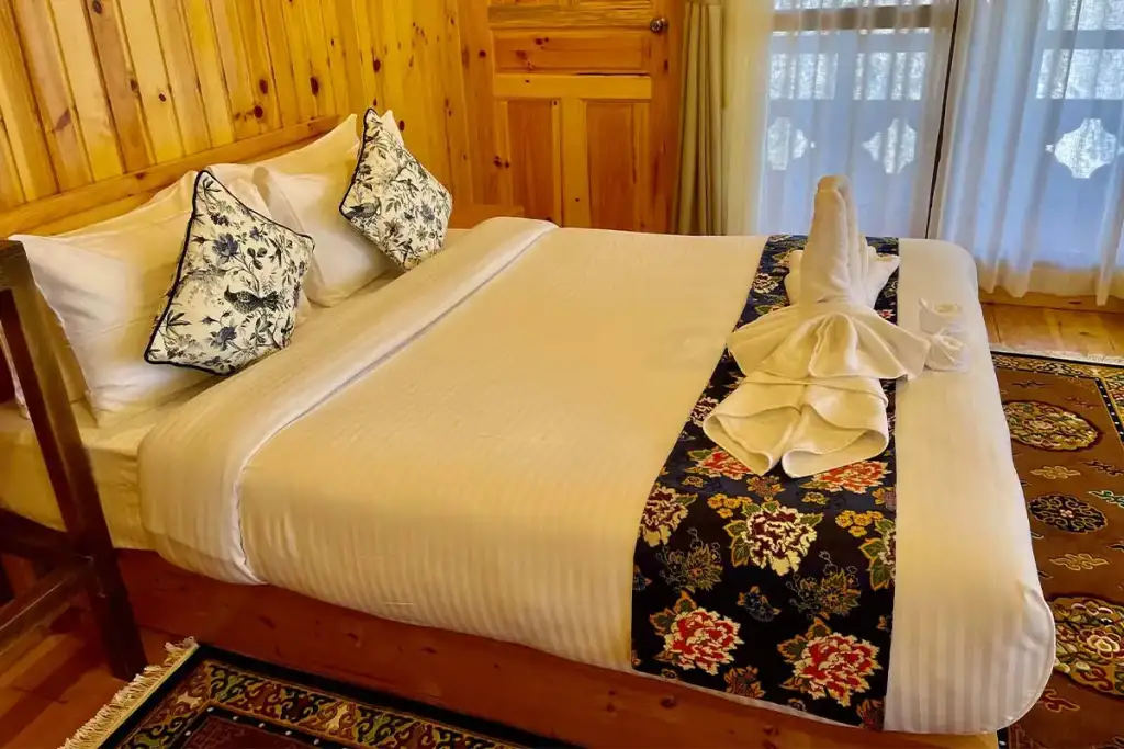 Suite with a queen bed and wood-panelled walls
