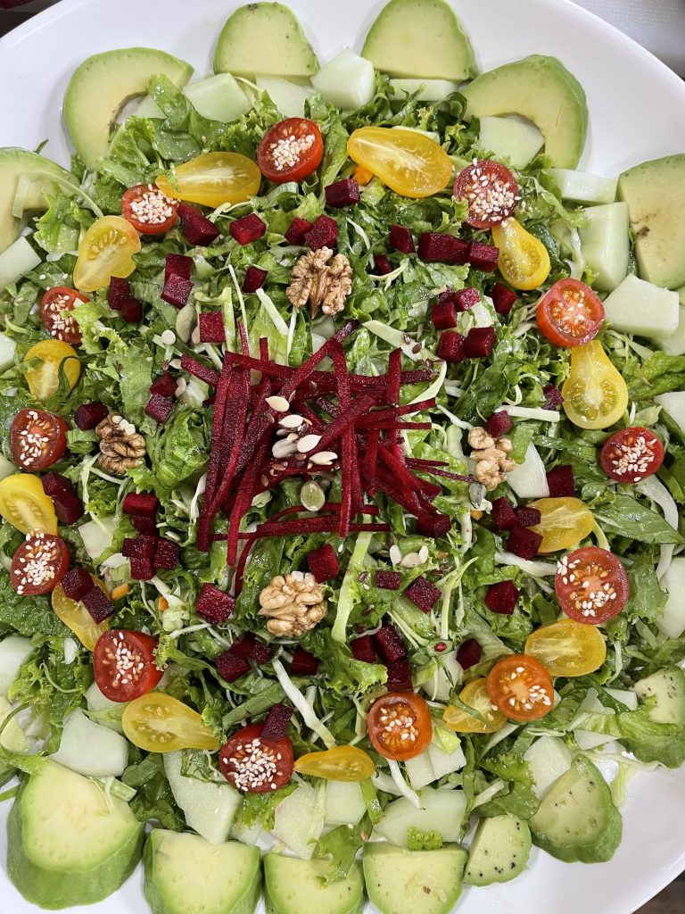 A salad of greens, beetroot, walnuts and cherry tomatoes