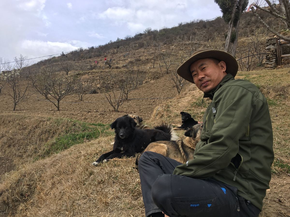 Dorji with his two dogs, taking a break