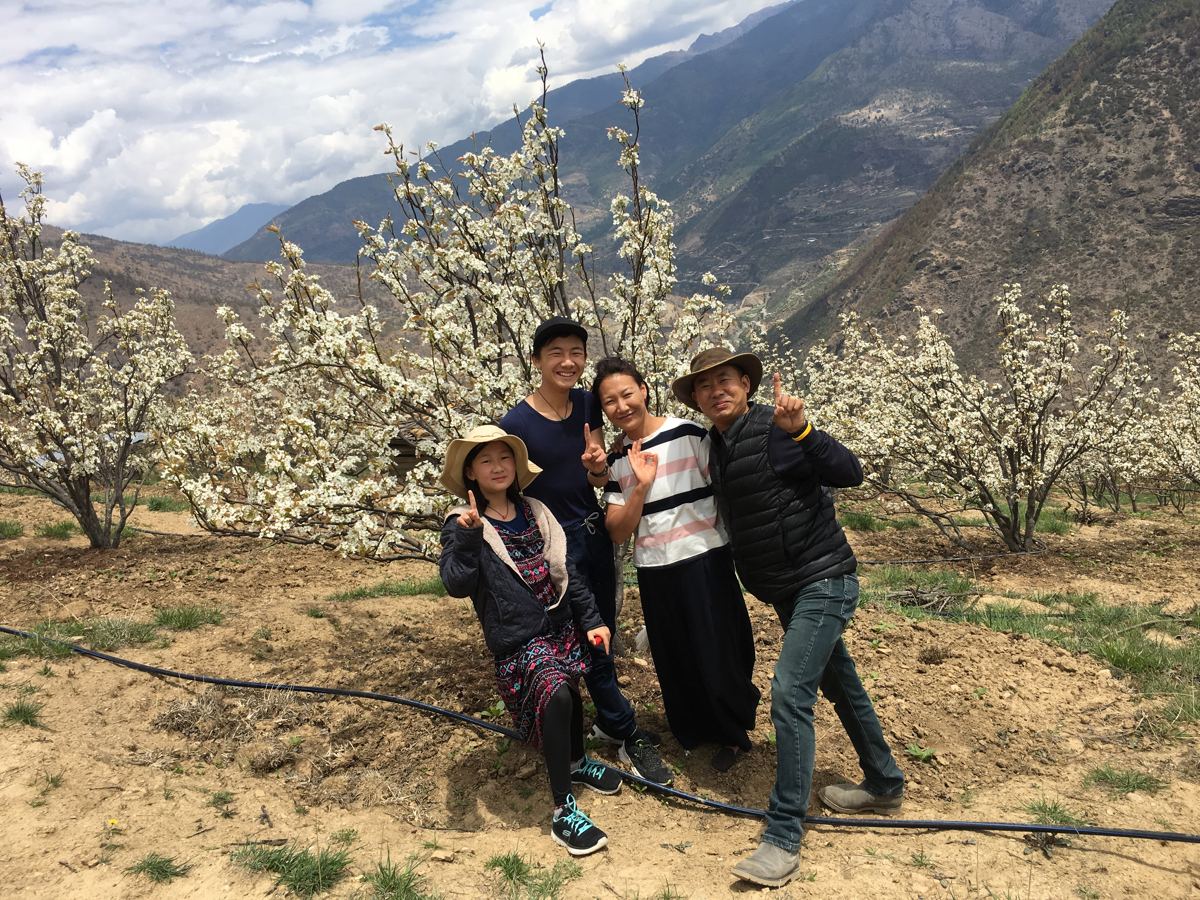 Dorji with his beautiful family in the orchard in spring